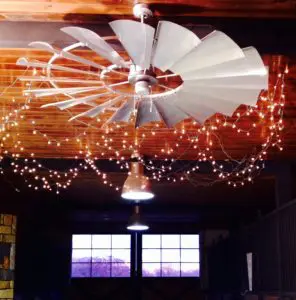 windmill ceiling fan cooling horses in barn